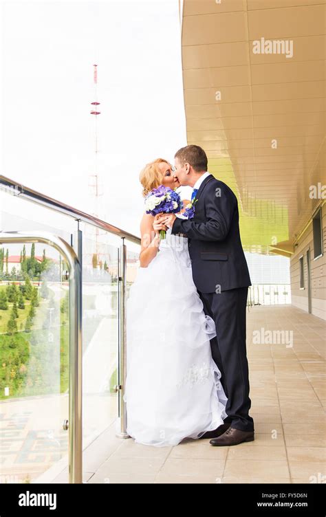 Handsome Brunette Groom Kissing Beautiful Bride In Wedding Dress Stock Photo Alamy