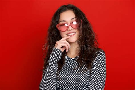 Young Woman Beautiful Portrait Posing On Red Background Long Curly