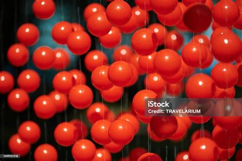 Red Balls Suspended On Wire Outdoor Art Object Symbolizing Blood Cells