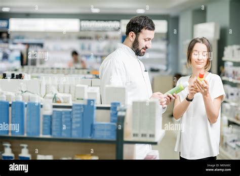 Pharmacist With Client At The Pharmacy Store Stock Photo Alamy