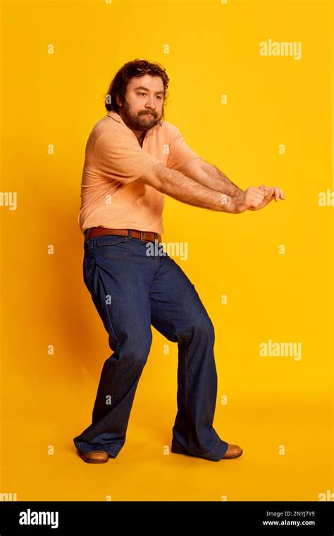 Studio Shot Of Mature Friendly Bearded Hairy Man Hippie In Stylish