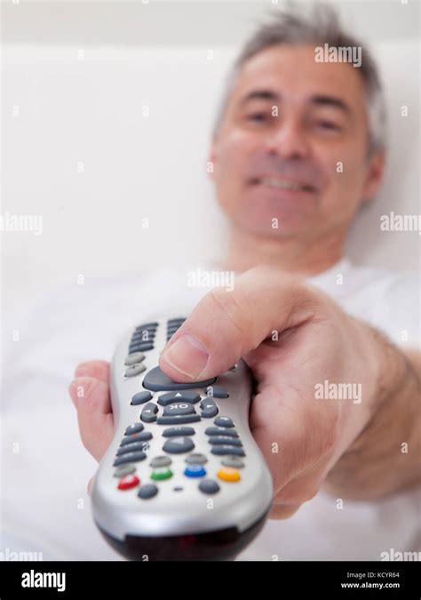 Portrait Of Happy Mature Man Holding Remote Control Stock Photo Alamy