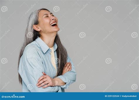 Mature White Haired Woman Laughing While Posing Arms Crossed Stock