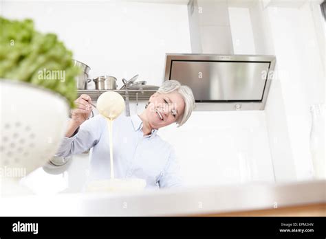 Mature Woman Baking In Kitchen Stock Photo Alamy