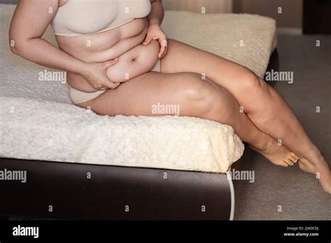 Cropped Photo Of Fat Plump Woman Sitting On Beige Plaid In Nude Bra