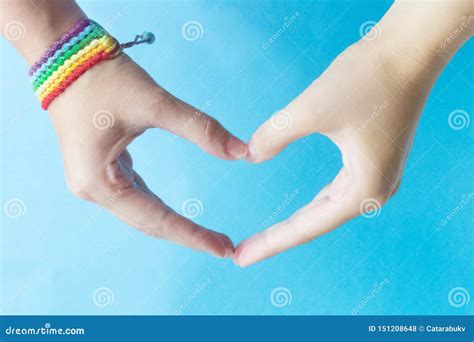 Two Hands In The Shape Of A Heart With A Bracelet With The Symbol Of