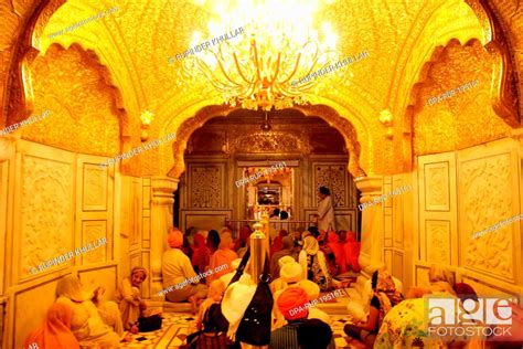 People sitting inside golden temple, amritsar, punjab, india, asia ...