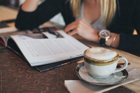 Blonde Woman Reading Book While Drinking Coffee By Stocksy Contributor Jovo Jovanovic Stocksy