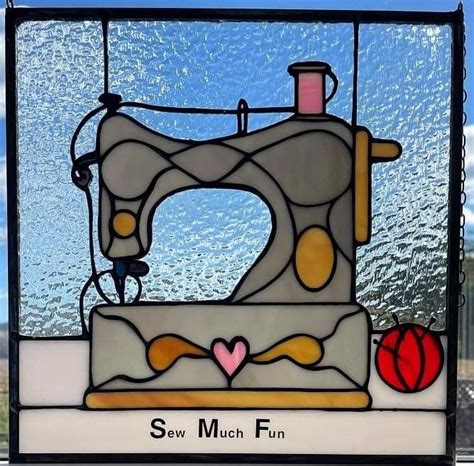 A Stained Glass Window With A Sewing Machine On It S Front And The