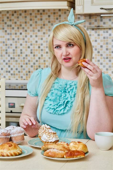 Plump Woman Sits Eating Homemade Baked Sweets At Stock Photo Image Of Blonde Hold