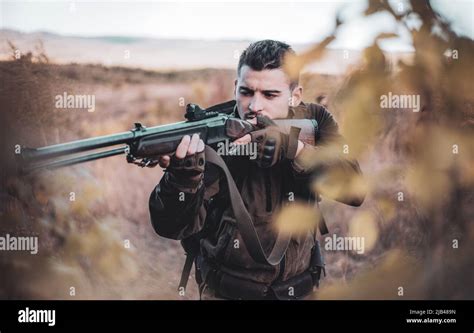 Hunter Aiming Rifle In Forest Hunter With Shotgun Gun On Hunt Track