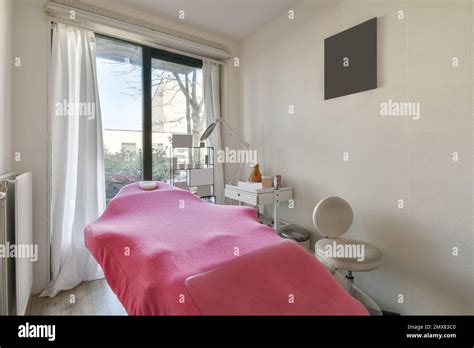 Beauty Salon Room With Table By The Window With White Walls Stock Photo