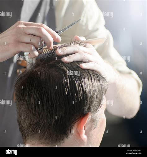 Man Getting Haircut At Barber Shop Hairdresser Cutting Hair Of