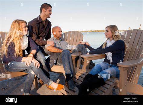 Two Gay Fathers Enjoy Quality Time At The Shore With Their Daughters On A Spring Summer Fall