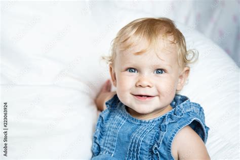 Close Up Portrait Of A Cute Baby Girl With Big Beautiful Blue Eyes And