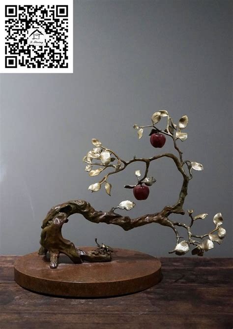 An Apple Tree Sculpture On A Wooden Table With Qr Code In The Back Ground