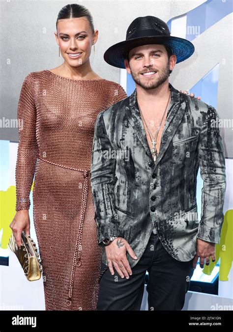 NEWARK, NEW JERSEY, USA - AUGUST 28: Brittany Carel and Christian Breslauer arrive at the 2022 ...