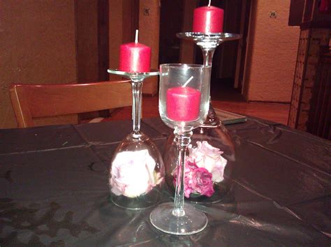 Upside Down Wine Glass With Flowers Under And Candle On Top Regular Wine Glass With Water And