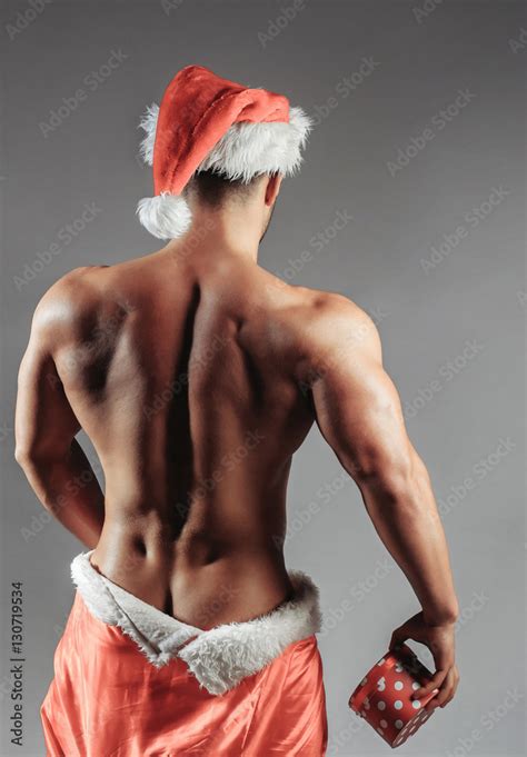 Naked Muscular Man With Santa Coat Stock Photo Adobe Stock