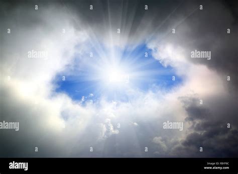 Sun Shining Through Hole In Clouds Stock Photo Alamy