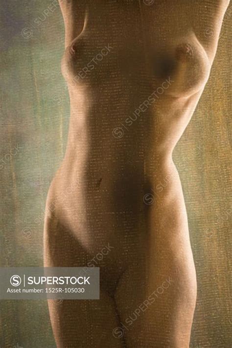 Nude Caucasian Woman Standing With Arms Raised Over Head SuperStock