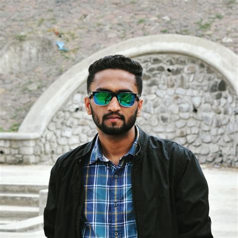 Premium Photo Portrait Of Man Wearing Sunglasses While Standing Against Wall