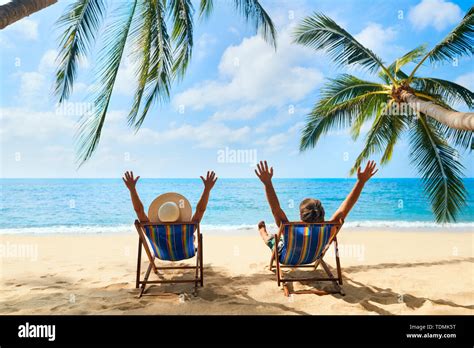 Happy Couple With Arms Up Relax On The Beach Enjoy Beautiful Sea On The Tropical Island Summer