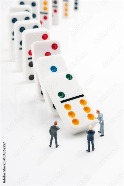 Domino effect concept of cascading errors or knock on effect of bad ...