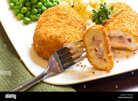 Breaded Stuffed Chicken Cordon Bleu With Green Peas White Rice And