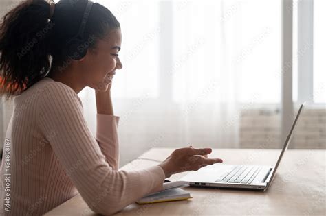 Side View A Multiracial Young Woman Wearing Headset Holding Video