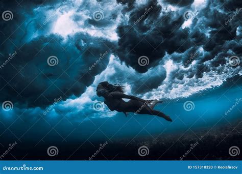 Woman In Bikini Dive Without Surfboard Underwater With Ocean Wave Duck