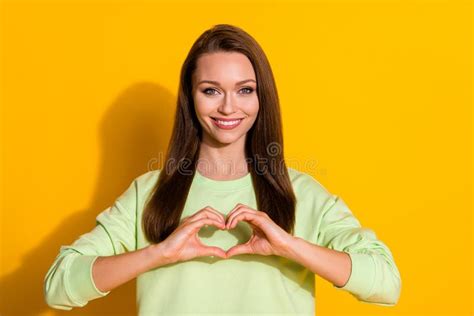 Photo Of Attractive Lady Good Mood Hold Arms Making Fingers Heart