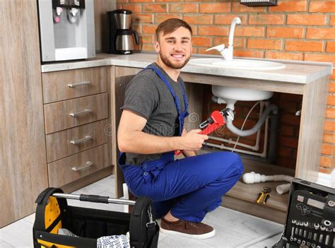 Professional Plumber in Uniform with Pipe Wrench Stock Photo - Image of ...