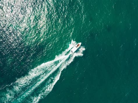 Premium Photo Aerial View Of Speed Boat At High Speed In The Aqua Sea