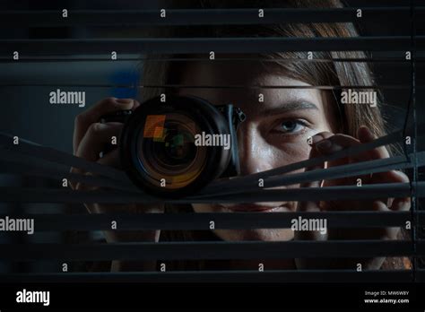 Young Woman Paparazzi Photographer Capturing A Photo Suspiciously From