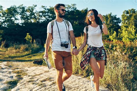 Beautiful Young Romantic Couple Of Tourists Holding Hands And Smiling