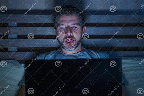 Man Alone In Bed Playing Cybersex Using Laptop Computer Watching Sex