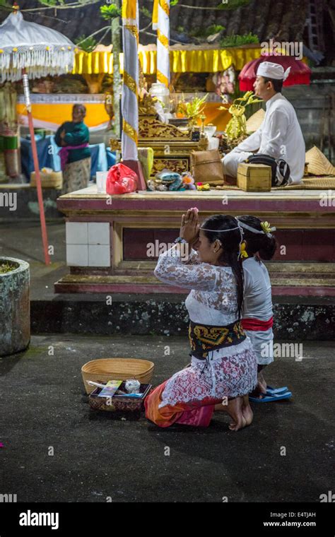 Bali Indonesia Young Women Praying In Hindu Temple Priest Sits On Platform Upper Right Pura