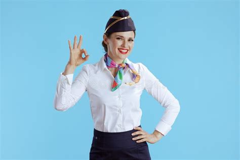 Happy Elegant Flight Attendant Woman On Blue Showing Ok Gesture Stock