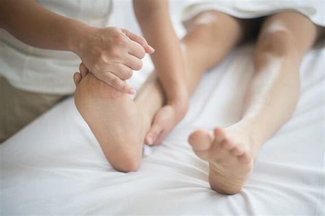 Premium Photo Midsection Of Woman Giving Massage To Customer Lying On Bed In Spa