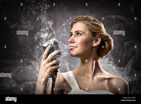 Beautiful Blonde Woman Singer With A Microphone Stock Photo Alamy