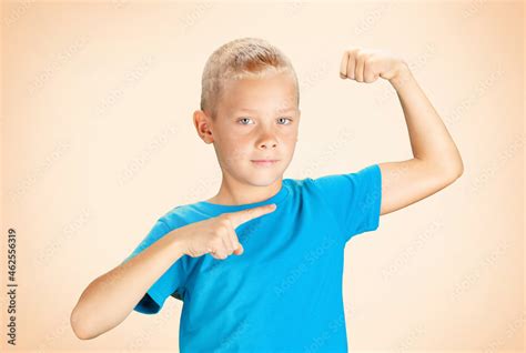 Funny boy showing his biceps muscles Stock Photo | Adobe Stock