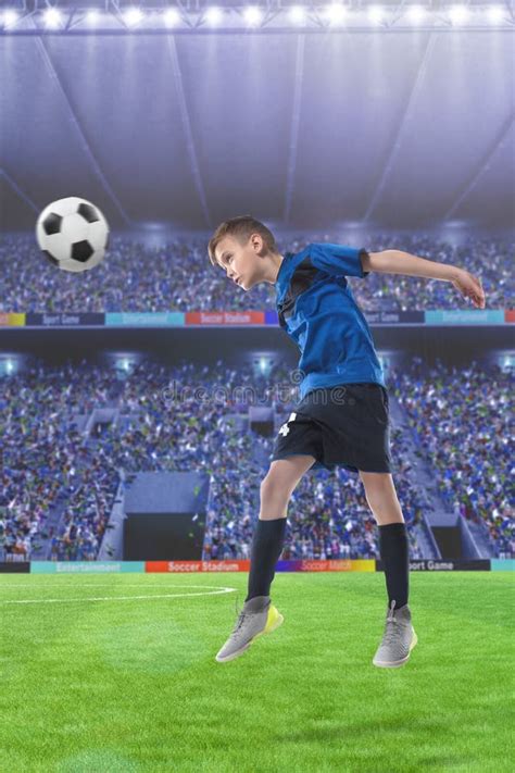 Football Player Hitting The Ball With Head On A Soccer Stadium Stock