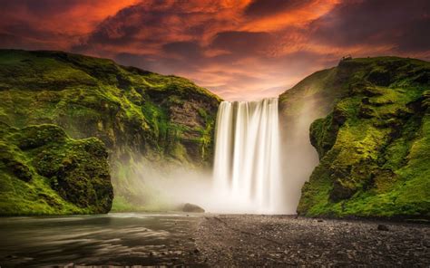 Wallpaper Waterfalls Under Cloudy Sky During Daytime Background