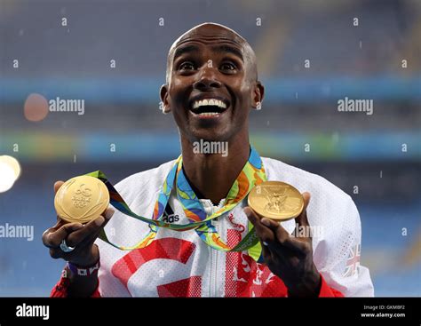 Great Britain's Mo Farah with his gold medals for victory in the Men's 5000m and 10000m on the ...