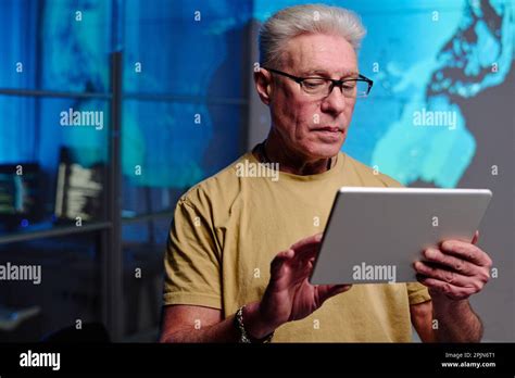 Serious Mature Businessman With Grey Hair Using Digital Tablet While