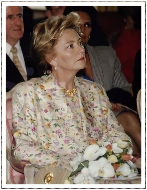 A Woman Sitting In A Chair With Flowers On Her Lap