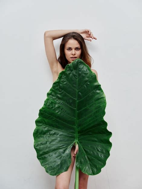 Premium Photo Woman With Naked Body Covers Herself With Green Leaf