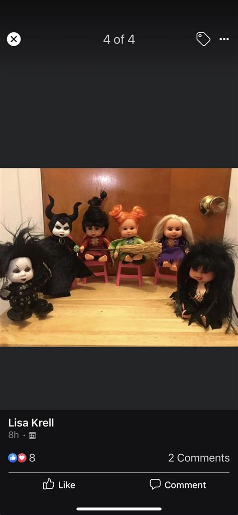 A Group Of Dolls Sitting On Top Of A Wooden Table