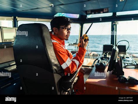 Filipino Deck Officer On Bridge Of Vessel Or Ship He Is Speaking On